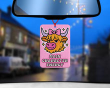 Load image into Gallery viewer, Pink reusable car air freshener featuring a girly Highland cow witha bow and the quote 'Main Character Energy' cute and funny car accessory for her, perfect for pink car decor and Highland cow gifts